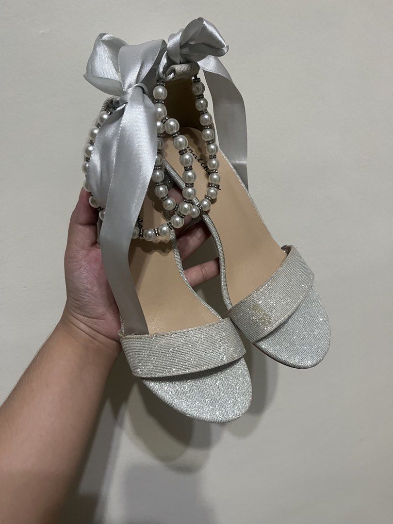 Matthews Silver Wedding Heels 👠 Size 35 | Never Worn (Category: Heels) located in Manila. Submitted by brightshark-0d45dd (Listing ID 1461497238, Image 1). Description: Bought this for my wedding but never got the chance to wear it. 🤍 ✨ Silver glitter finish ✨ Pearl & satin ribbon details ✨ Block heels ✨ Size 35 ✨ Never worn — soles still clean 📌 Please note: May slight discoloration on the front strap due to long-term storage. Kindly check al