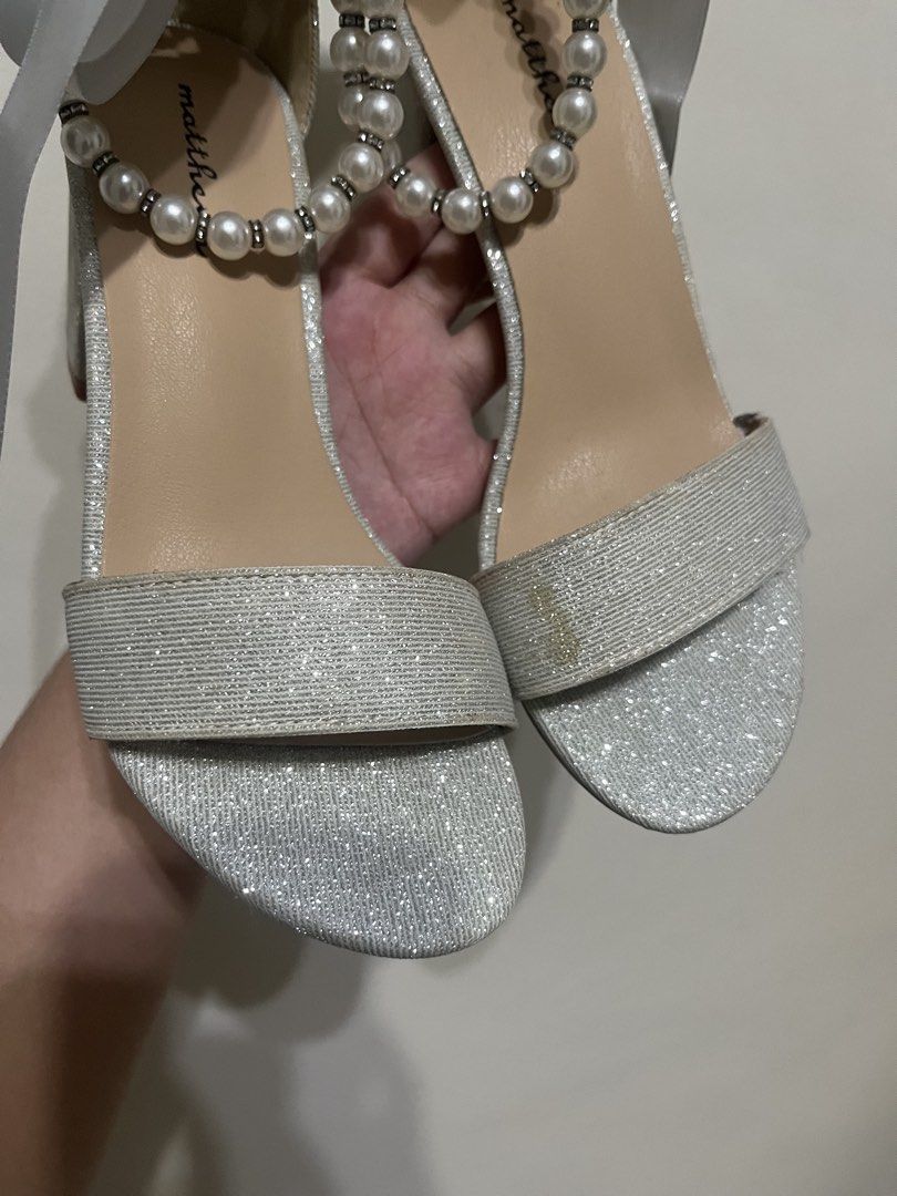 Matthews Silver Wedding Heels 👠 Size 35 | Never Worn (Category: Heels) located in Manila. Submitted by brightshark-0d45dd (Listing ID 1461497238, Image 3). Description: Bought this for my wedding but never got the chance to wear it. 🤍 ✨ Silver glitter finish ✨ Pearl & satin ribbon details ✨ Block heels ✨ Size 35 ✨ Never worn — soles still clean 📌 Please note: May slight discoloration on the front strap due to long-term storage. Kindly check al