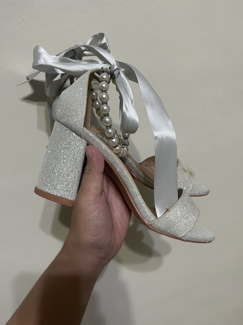 Matthews Silver Wedding Heels 👠 Size 35 | Never Worn (Category: Heels) located in Manila. Submitted by brightshark-0d45dd (Listing ID 1461497238, Image 2). Description: Bought this for my wedding but never got the chance to wear it. 🤍 ✨ Silver glitter finish ✨ Pearl & satin ribbon details ✨ Block heels ✨ Size 35 ✨ Never worn — soles still clean 📌 Please note: May slight discoloration on the front strap due to long-term storage. Kindly check al