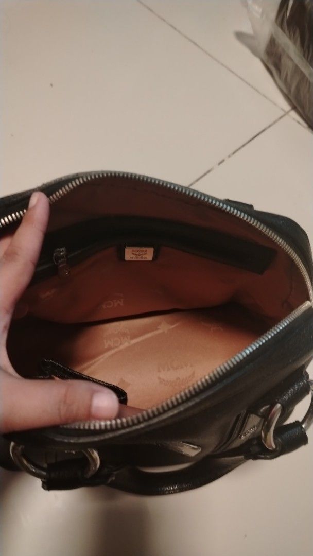 MCM Black Leather Studded Boston Bag (Category: Luxury Bags & Wallets) located in Manila. Submitted by wildwind_73f77a (Listing ID 1461501886, Image 3). Description: - Authentic black leather MCM Boston bag - Eye-catching silver hardware and all-over stud detailing - Interior MCM logo lining - Convenient interior zip pocket - Sturdy and comfortable handles - Secure zipper closure - Ideal for daily use.