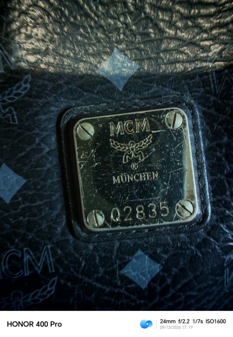 MCM Tote Bag Black Monogram (Category: Luxury Bags & Wallets) located in Manila. Submitted by cleverwhale_45b7bc (Listing ID 1461432317, Image 2). Description: - Classic MCM tote bag - Black with signature monogram pattern - Leather handles and trim - Interior: zippered pocket and open compartments - Note: Some stains inside the main compartment - Metal logo plate on the front -turnable screw.
