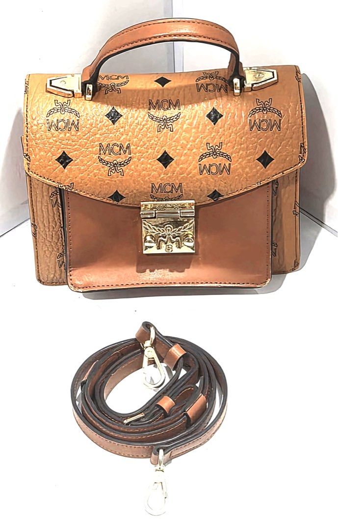 MCM Visetos Mini Top Handle Bag/Sling Bag (Category: Luxury Bags & Wallets) located in Antipolo. Submitted by shopaho_nique (Listing ID 1459587275, Image 1). Description: - MCM Mini Top Handle Bag - Classic Visetos Print - Detachable Shoulder Strap Included - Gold-Tone Hardware with MCM Logo Clasp - Minor signs of wear on hardware and handle - Ideal for everyday use - Please check all photos & details carefully before buying. Sold as is / as show