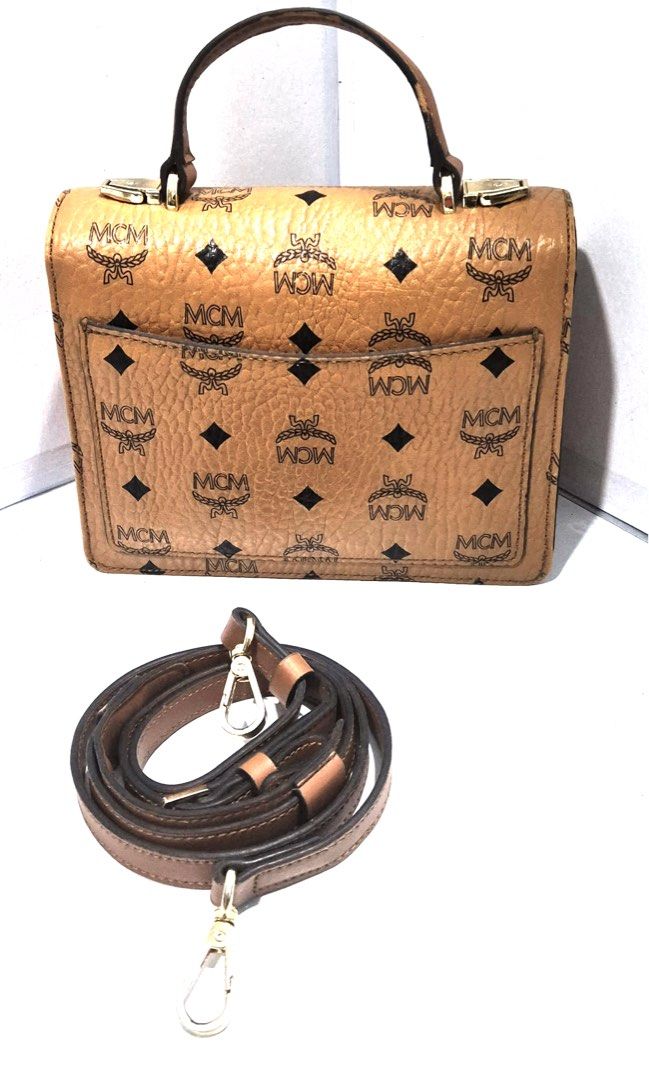 MCM Visetos Mini Top Handle Bag/Sling Bag (Category: Luxury Bags & Wallets) located in Antipolo. Submitted by shopaho_nique (Listing ID 1459587275, Image 2). Description: - MCM Mini Top Handle Bag - Classic Visetos Print - Detachable Shoulder Strap Included - Gold-Tone Hardware with MCM Logo Clasp - Minor signs of wear on hardware and handle - Ideal for everyday use - Please check all photos & details carefully before buying. Sold as is / as show