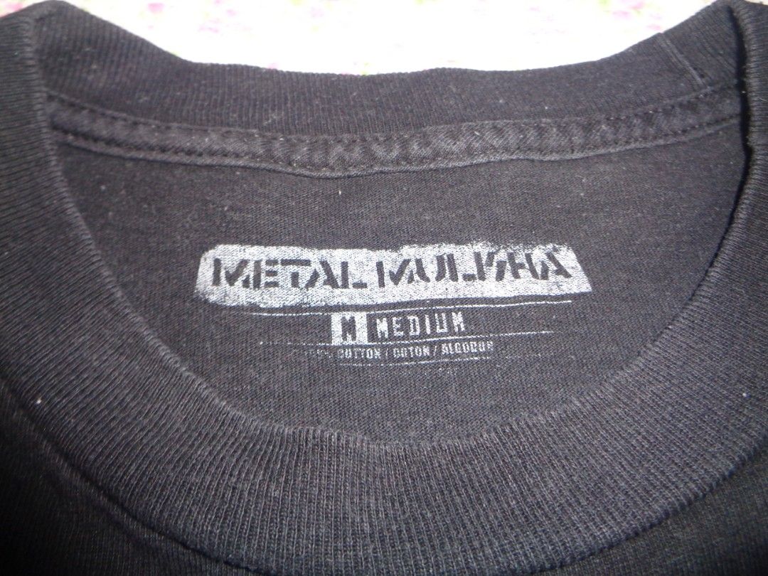 Metal Mulisha Graphic Tee (Category: Tshirts & Polo Shirts ) located in Batangas. Submitted by gelidium_lloyd (Listing ID 1461556691, Image 3). Description: - Black Metal Mulisha graphic tee - Size: Medium - Material: Cotton - Unique design featuring flamingos, campers, and pin-up style figures - Ideal for casual wear.