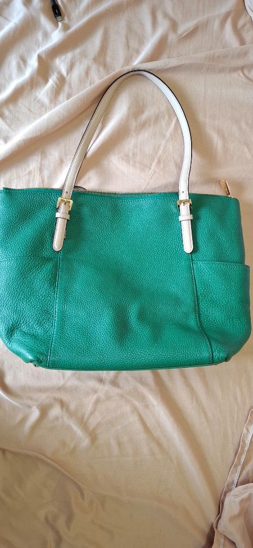 Michael Kors Green Leather Tote Bag (Category: Tote Bags) located in Manila. Submitted by rafaelskie_17 (Listing ID 1461559319, Image 1). Description: - Michael Kors green pebbled leather tote bag - Beige interior lining with MK logo pattern - Secure zip top closure - Elegant gold hardware details - Two comfortable shoulder straps with buckle accents - Multiple interior pockets for organization - Ideal everyday bag.