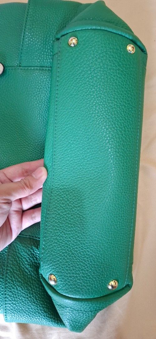 Michael Kors Green Leather Tote Bag (Category: Tote Bags) located in Manila. Submitted by rafaelskie_17 (Listing ID 1461559319, Image 2). Description: - Michael Kors green pebbled leather tote bag - Beige interior lining with MK logo pattern - Secure zip top closure - Elegant gold hardware details - Two comfortable shoulder straps with buckle accents - Multiple interior pockets for organization - Ideal everyday bag.