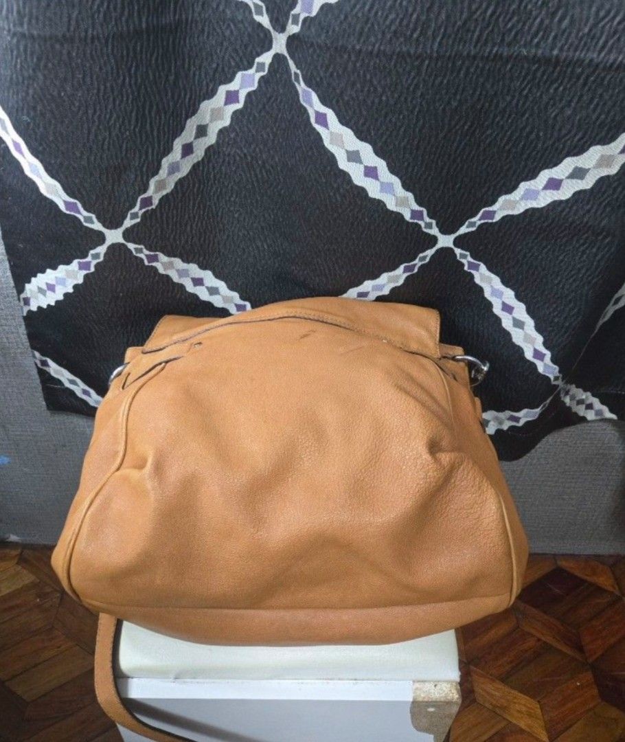 Michael Kors Leather Shoulder Bag (Category: Other Accessories) located in Quezon City. Submitted by affordabags_cd (Listing ID 1461388463, Image 3). Description: - Authentic Michael Kors shoulder bag - Rich brown pebbled leather - Secure turn-lock closure with MK logo - Adjustable strap for comfortable wear - Comes with authenticity cards.