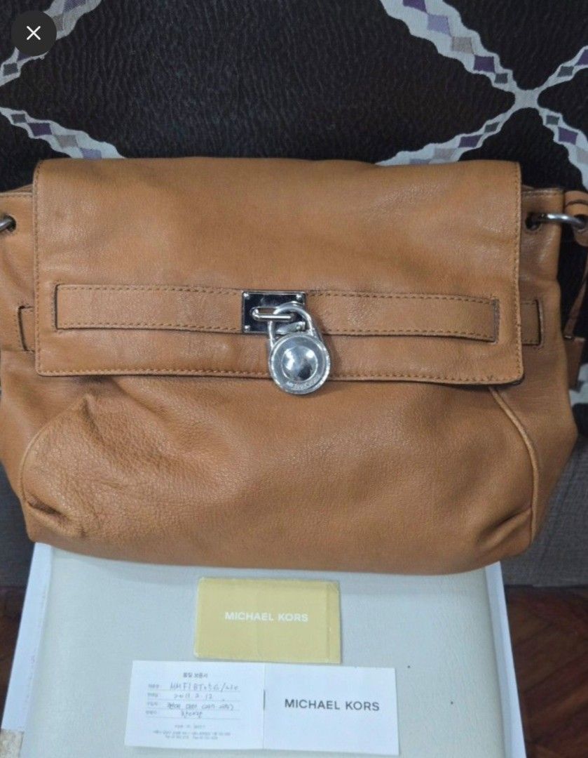 Michael Kors Leather Shoulder Bag (Category: Other Accessories) located in Quezon City. Submitted by affordabags_cd (Listing ID 1461388463, Image 1). Description: - Authentic Michael Kors shoulder bag - Rich brown pebbled leather - Secure turn-lock closure with MK logo - Adjustable strap for comfortable wear - Comes with authenticity cards.