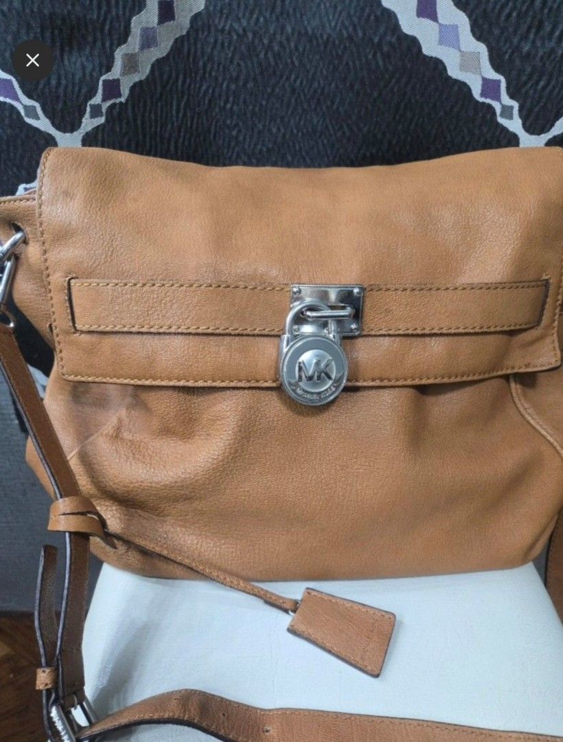 Michael Kors Leather Shoulder Bag (Category: Other Accessories) located in Quezon City. Submitted by affordabags_cd (Listing ID 1461388463, Image 2). Description: - Authentic Michael Kors shoulder bag - Rich brown pebbled leather - Secure turn-lock closure with MK logo - Adjustable strap for comfortable wear - Comes with authenticity cards.