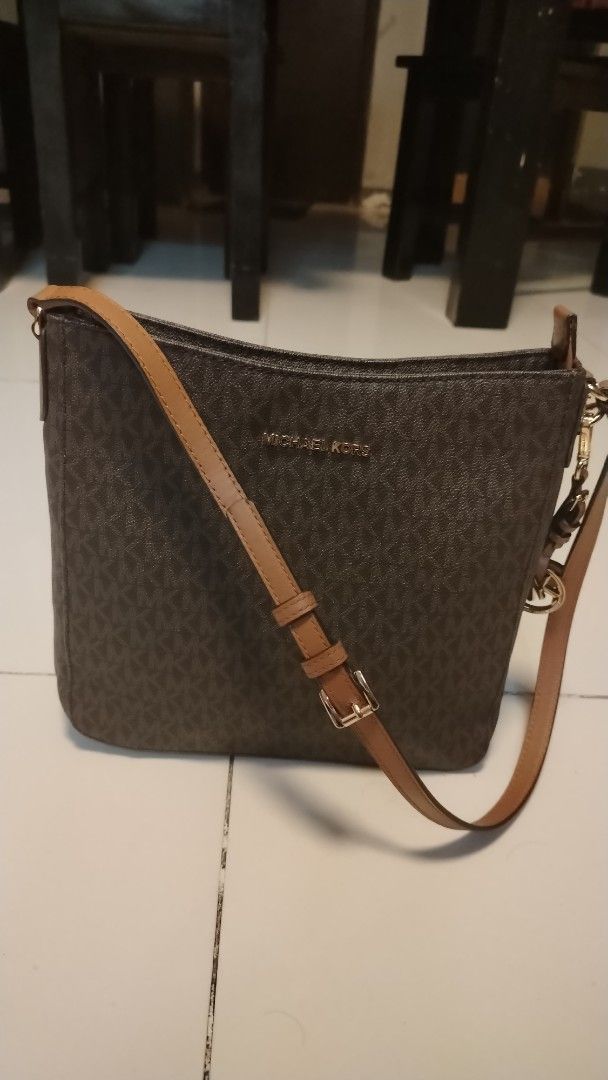 Michael Kors Monogram Shoulder Bag (Category: Luxury Bags & Wallets) located in Manila. Submitted by wildwind_73f77a (Listing ID 1461486040, Image 1). Description: - Authentic Michael Kors shoulder bag in classic brown. - Features the iconic all-over MK monogram pattern. - Accented with stylish tan leather strap and details. - Elegant gold-tone hardware throughout. - Includes the signature MK charm for an extra touch of luxury. - A versatile and 