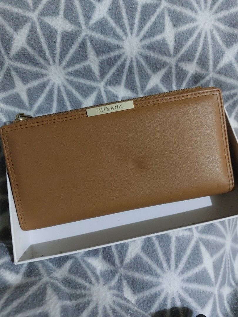 Mikana brown long wallet (Category: Wallets & Card holders) located in Antipolo. Submitted by ms.marieyahs (Listing ID 1461423361, Image 2). Description: Used once and na stock na sa drawer, may dents as you can see sa photos dahil sa kakatago.. but overall goods pa sya.. - can send more photos if needed. - lalamove shouldered by buyer.. - you may check my profile just in case may iba pang magustuhan. tnx!.