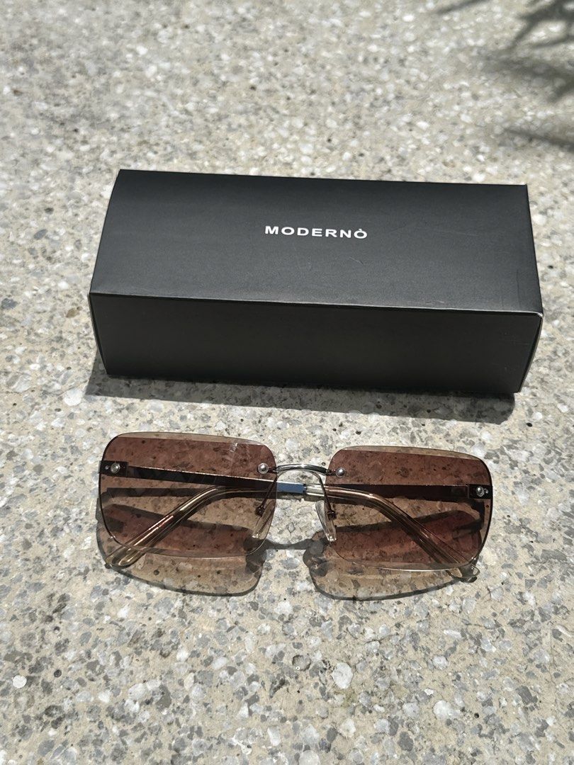 MODERNÒ Rimless Gradient Sunglasses with Box (Category: Sunglasses & Eyewear) located in Pasig City. Submitted by AlbertCruz97 (Listing ID 1461419523, Image 1). Description: - MODERNÒ rimless sunglasses - Gradient brown lenses - Silver metal frame - Comes with original MODERNÒ box - Ideal for sunny days - Stylish accessory.