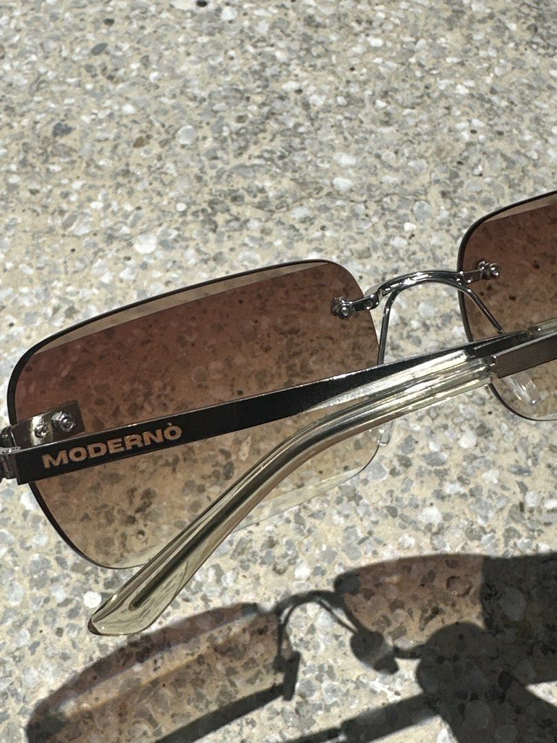 MODERNÒ Rimless Gradient Sunglasses with Box (Category: Sunglasses & Eyewear) located in Pasig City. Submitted by AlbertCruz97 (Listing ID 1461419523, Image 2). Description: - MODERNÒ rimless sunglasses - Gradient brown lenses - Silver metal frame - Comes with original MODERNÒ box - Ideal for sunny days - Stylish accessory.