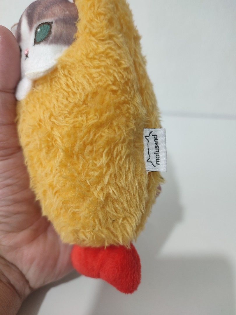 Mofusand Yellow Fluffy Cat Plush Keychain (Category: Plushies & Soft Toys) located in Manila. Submitted by epicmountain-f20453 (Listing ID 1461513051, Image 2). Description: - Adorable Mofusand plush keychain - Bright yellow color with a cute cat face - Features a charming little red foot detail - Ideal for attaching to bags, backpacks, or purses - A must-have for any Mofusand enthusiast!.