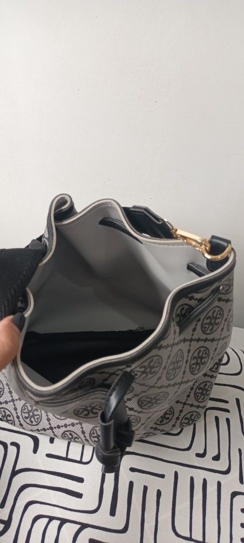 Monogram Bucket Bag with Adjustable Strap (Category: Luxury Bags & Wallets) located in Mandaluyong City. Submitted by chassie25 (Listing ID 1461397733, Image 2). Description: - Stylish black and grey monogram pattern all over. - Secure drawstring closure. - Comfortable black strap. - Elegant gold hardware details. - Spacious interior, perfect for daily essentials. - Clean and well-maintained, inside and out..