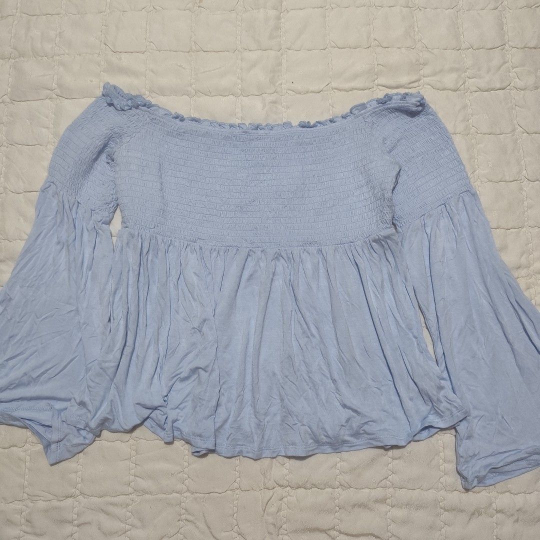 Mossimo Light Blue Smocked Off-the-Shoulder Top (Category: Others Tops) located in Bacolod City. Submitted by dearicawho.56 (Listing ID 1461477466, Image 1). Description: - Light blue off-the-shoulder top - Brand: Mossimo Supply Co. - Features: Smocked bodice, flowy bell sleeves - Material: Soft rayon and spandex blend - Versatile: Great for casual outings or nights with friends - Styling: Easily pairs with jeans or shorts 🧾Mode of payment: 💙Gc