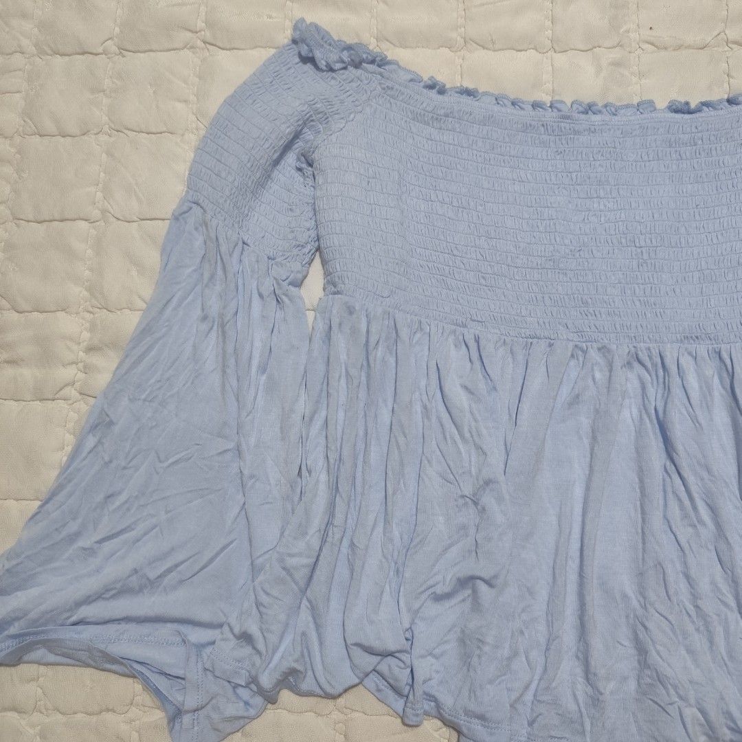 Mossimo Light Blue Smocked Off-the-Shoulder Top (Category: Others Tops) located in Bacolod City. Submitted by dearicawho.56 (Listing ID 1461477466, Image 2). Description: - Light blue off-the-shoulder top - Brand: Mossimo Supply Co. - Features: Smocked bodice, flowy bell sleeves - Material: Soft rayon and spandex blend - Versatile: Great for casual outings or nights with friends - Styling: Easily pairs with jeans or shorts 🧾Mode of payment: 💙Gc