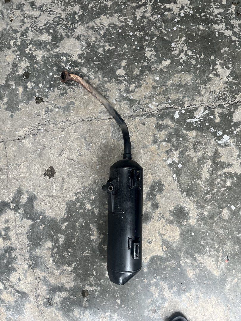 Motorcycle Exhaust Muffler Pipe (Category: Mufflers, Exhaust Parts & Accessories) located in Manila. Submitted by keanuchedi94156 (Listing ID 1461408774, Image 1). Description: - Black motorcycle exhaust muffler - Features a bent pipe design - Still fully functional and in working condition - Removed from a running motorcycle - Ready for its next owner.
