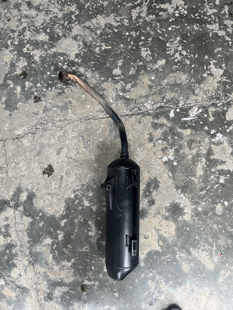 Motorcycle Exhaust Muffler Pipe (Category: Mufflers, Exhaust Parts & Accessories) located in Manila. Submitted by keanuchedi94156 (Listing ID 1461408774, Image 2). Description: - Black motorcycle exhaust muffler - Features a bent pipe design - Still fully functional and in working condition - Removed from a running motorcycle - Ready for its next owner.
