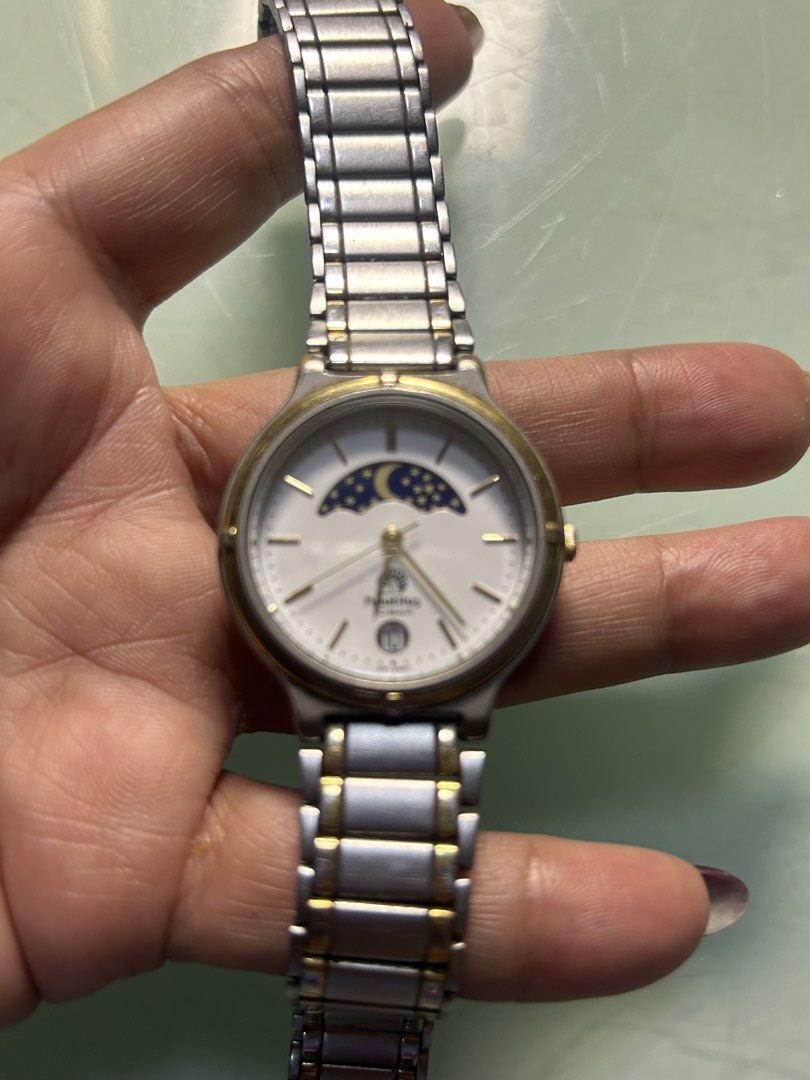 Nautilus Watch - Moon Phase - Water Resistant 10 Bar (Category: Women's Watches) located in Cavite. Submitted by mamamia73 (Listing ID 1461547652, Image 2). Description: Nautilus watch with moon phase. White dial, gold accents, stainless steel band. Water resistant 10 bar. Model DHT-2900. Assembled in China. Perfect for daily wear..