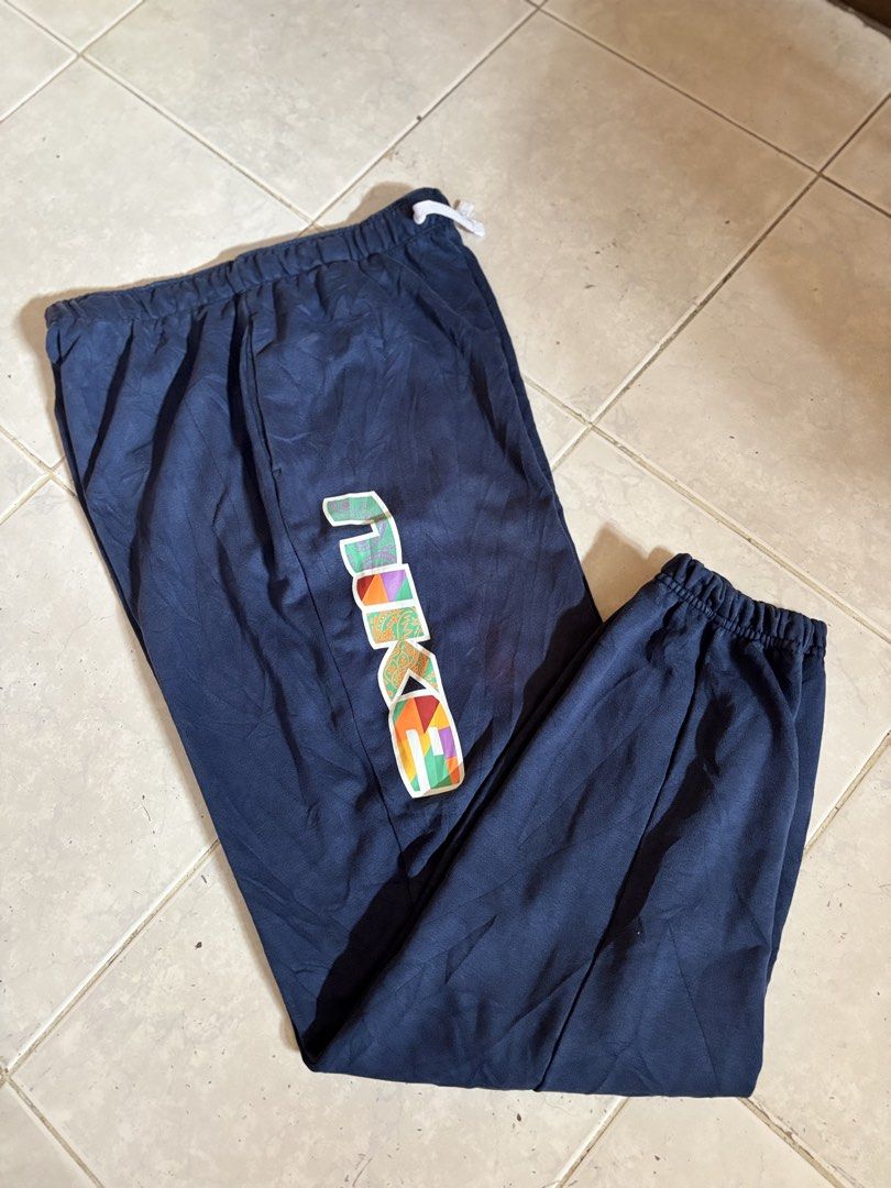 Navy Blue Sweatpants with Colorful Logo (Category: Other Bottoms) located in Manila. Submitted by manifest_05 (Listing ID 1461516364, Image 1). Description: - Navy blue sweatpants - Colorful graphic logo on left leg - Drawstring waist for adjustable fit - Elasticated cuffs at the ankles - Comfortable and casual design - Perfect for lounging or workouts - Easy to pair with t-shirts and hoodies.