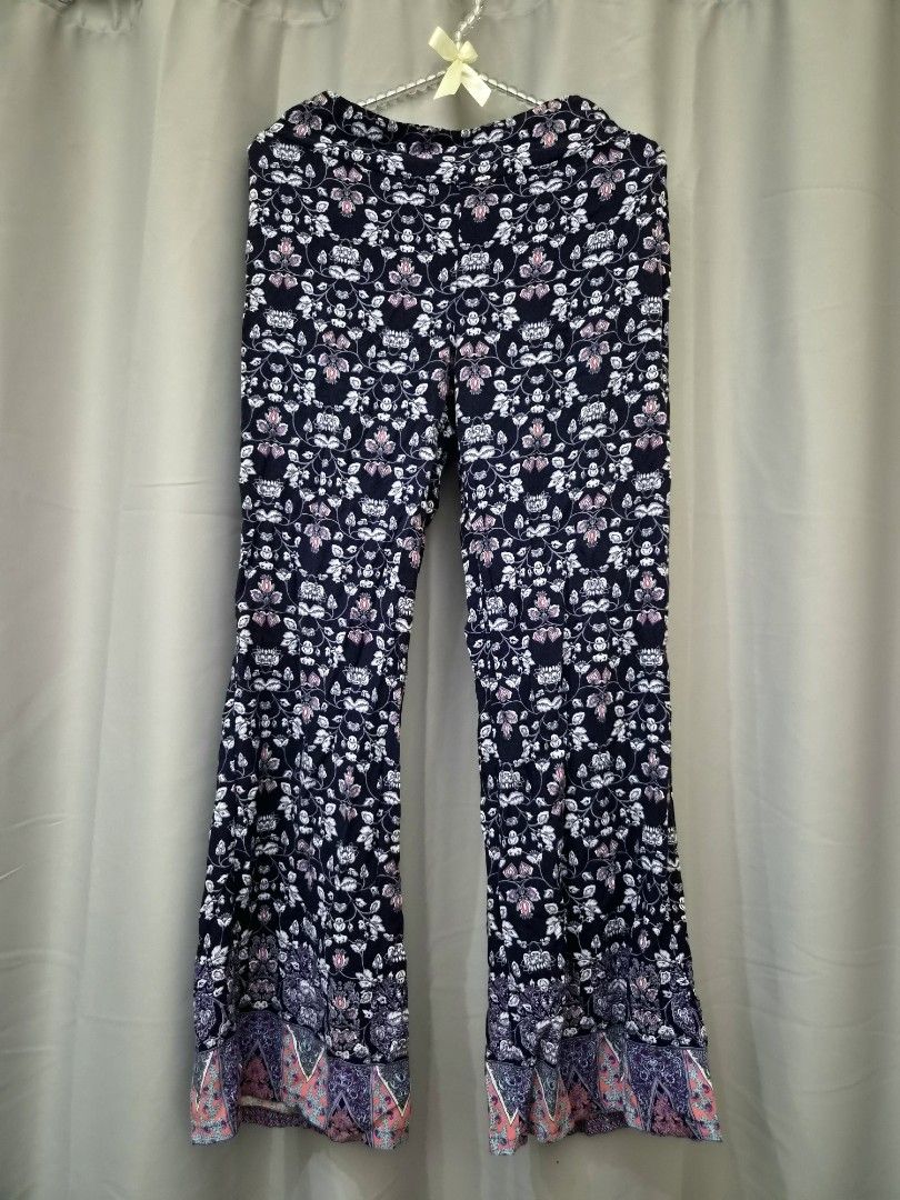 Navy Floral Bell Bottom Pants with Border Print (Category: Other Bottoms) located in Manila. Submitted by manoygoodies (Listing ID 1461402415, Image 1). Description: - Navy blue pants with a vibrant all-over floral print (pink & white flowers, green leaves). - Flared leg silhouette. - Decorative border print at the hem. - Comfortable elastic waistband. - Perfect for achieving a boho-chic look..