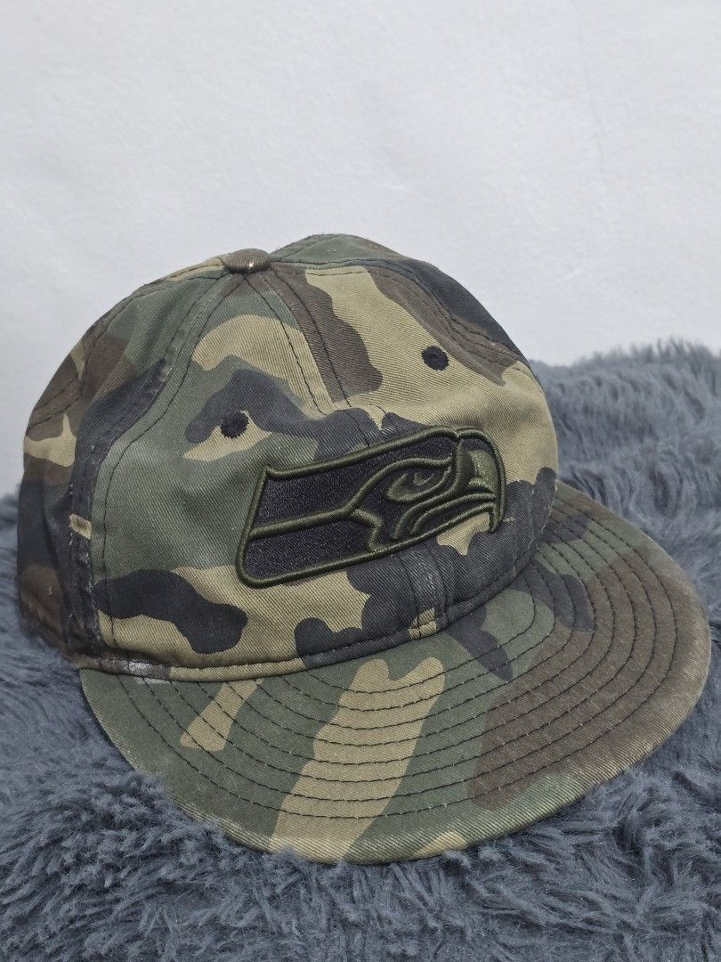 New Era Camo Snapback Cap (Category: Caps & Hats) located in Manila. Submitted by trialfindsmanila (Listing ID 1461504495, Image 1). Description: still in good condition, pakilabhan nalang. hindi masyado nagagamit. - Camo print snapback cap - Black embroidered logo on front - New Era branding on side - Adjustable snap closure - Classic baseball cap style.