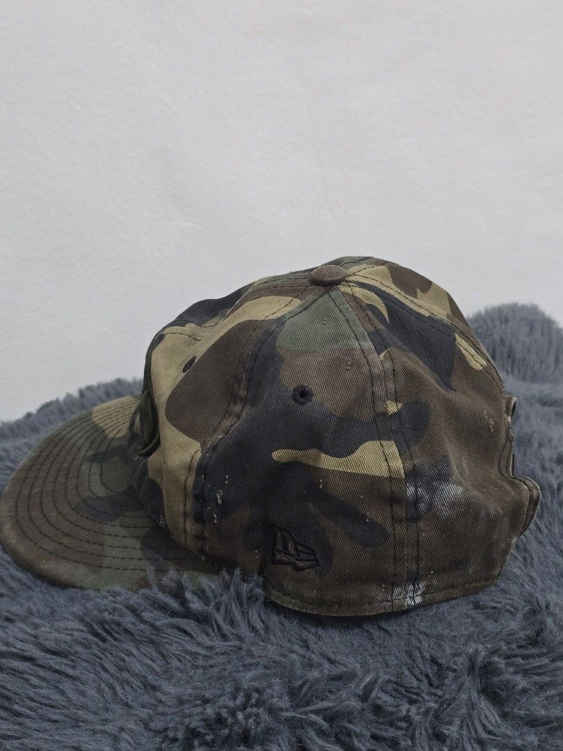 New Era Camo Snapback Cap (Category: Caps & Hats) located in Manila. Submitted by trialfindsmanila (Listing ID 1461504495, Image 3). Description: still in good condition, pakilabhan nalang. hindi masyado nagagamit. - Camo print snapback cap - Black embroidered logo on front - New Era branding on side - Adjustable snap closure - Classic baseball cap style.