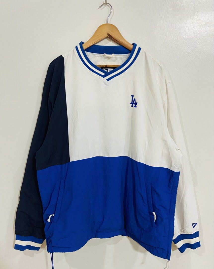 New Era LA Dodgers Pullover Jacket XL (Category: Coats, Jackets and Outerwear) located in Manila. Submitted by thriftnijuan08 (Listing ID 1461339157, Image 1). Description: - Authentic New Era LA Dodgers pullover jacket - Stylish white, blue, and navy color block design - Iconic embroidered LA logo on the chest - V-neck collar with classic blue and white stripes - Adjustable drawstring hem for a custom fit - Size XL - A must-have for any Los Ange
