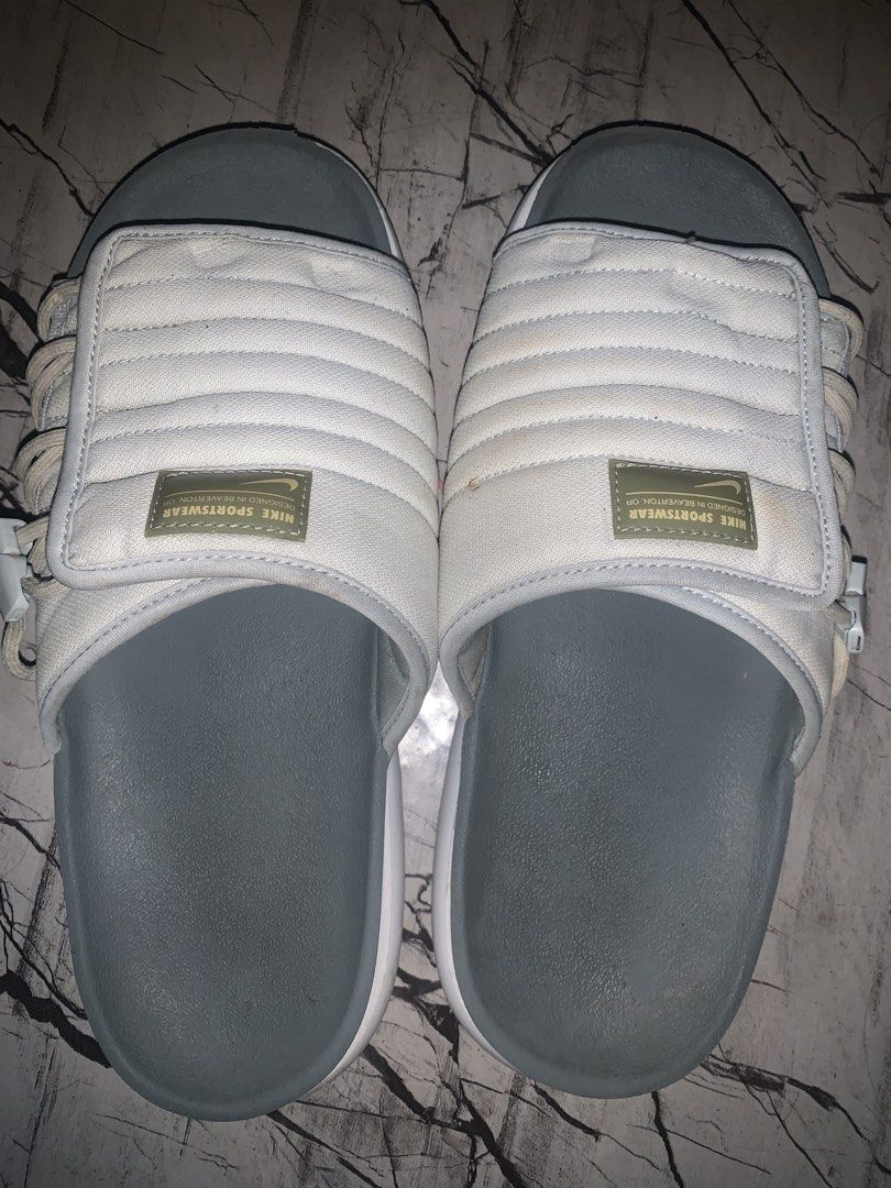 Nike Asuna 2 slides (Category: Slippers & Slides) located in San Mateo. Submitted by andiemoto (Listing ID 1461417046, Image 1). Description: - White Nike slides with grey soles - Adjustable strap closure - Size: US 8 / UK 7 / EUR 41 / CM 26 - Minor dirt on soles from normal wear - Ideal for casual wear.