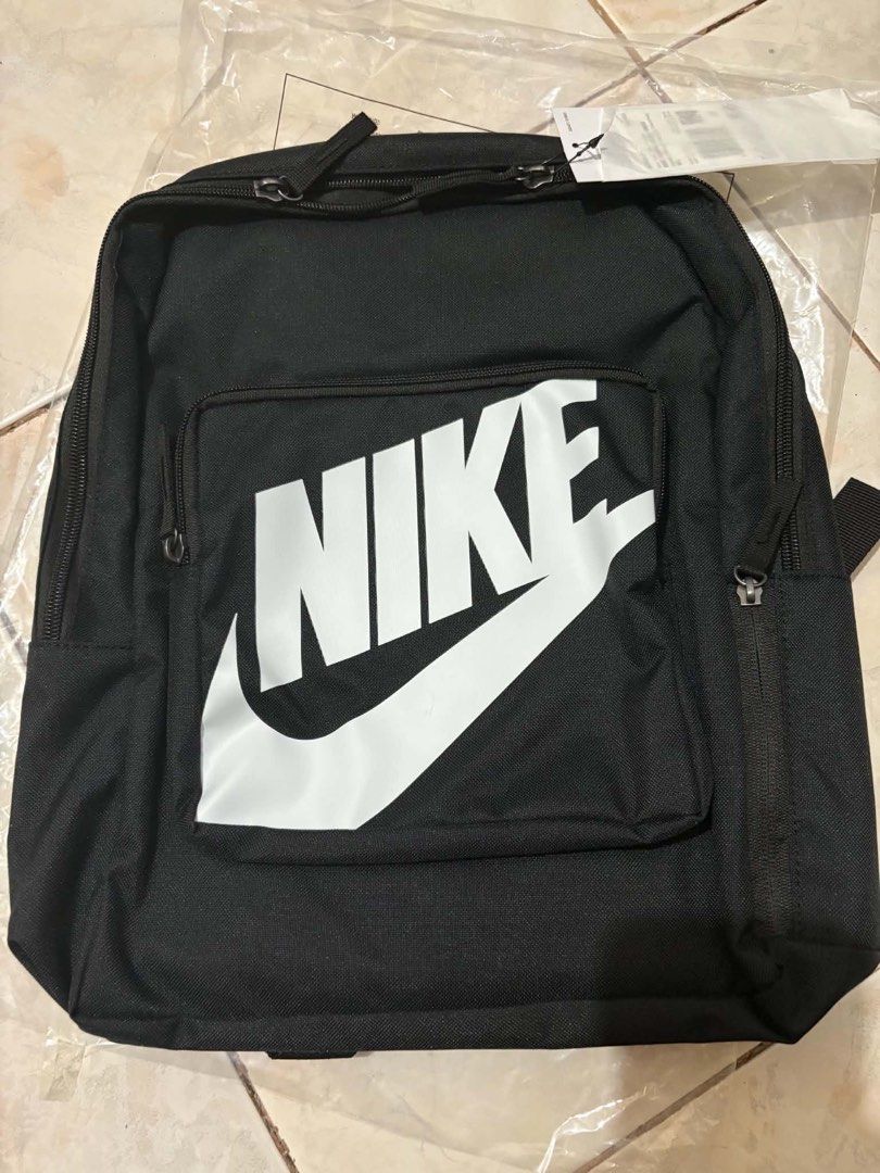 Nike Black Backpack with Large White Swoosh Logo (Category: Backpacks) located in Mandaluyong City. Submitted by annezoe (Listing ID 1461519866, Image 2). Description: -Brandnew and Legit💯 -Srp: 1,395 selling for only 650 - Classic black Nike backpack 16 L -2 pcs Available - Front zip pocket - Adjustable shoulder straps for comfort - Ideal for school, gym, or everyday use - Still in original packaging, with tags.