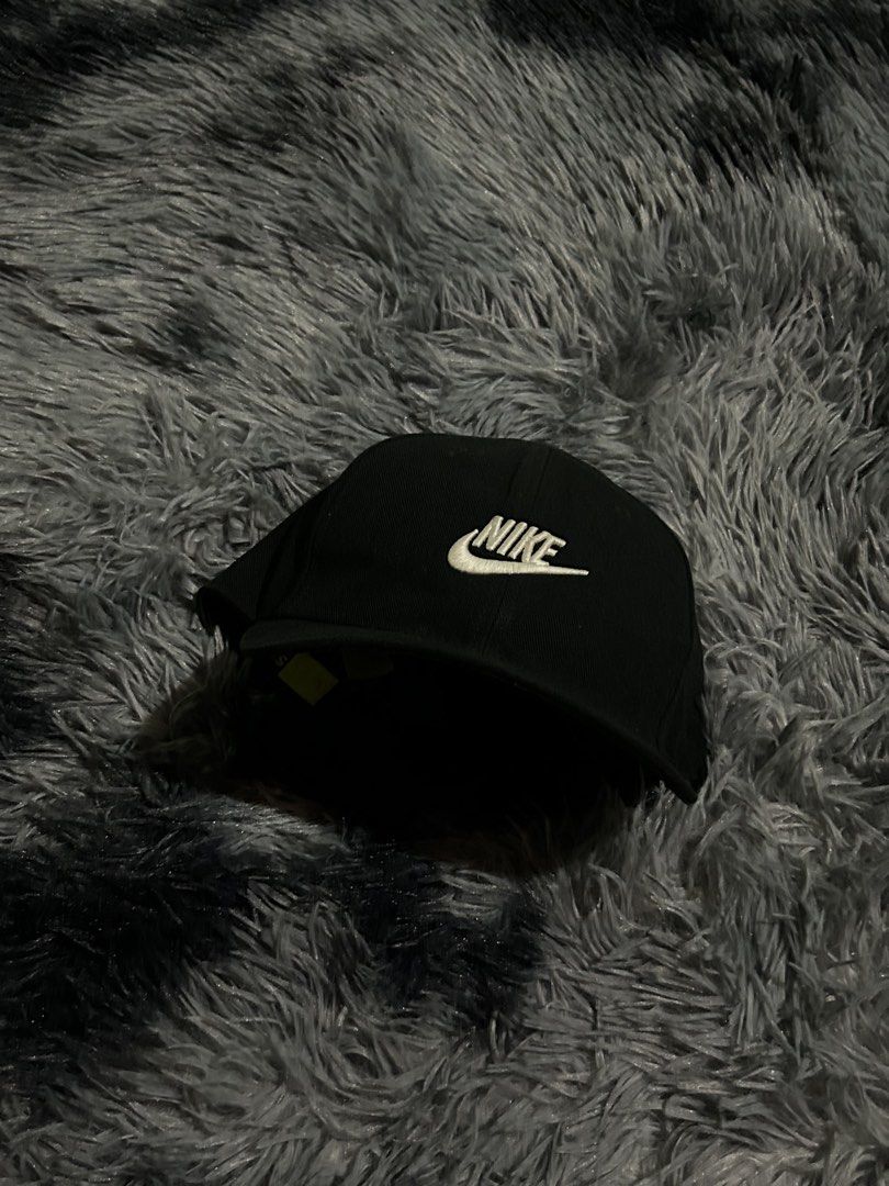 Nike Black Cap "Just Do It" (Category: Caps & Hats) located in Cadiz. Submitted by jaybatiller (Listing ID 1461325798, Image 3). Description: - Classic black Nike cap - Iconic white embroidered Nike logo on front - Adjustable snapback closure - 'Just Do It' slogan printed on strap - Ideal for everyday wear or sports.