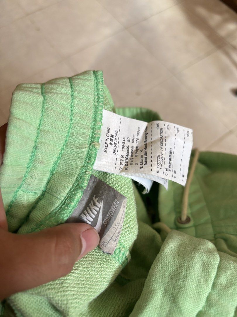 Nike Green Sweat Shorts XL (Category: Shorts) located in Manila. Submitted by manifest_05 (Listing ID 1461328272, Image 2). Description: - Green Nike sweat shorts - Size XL - Features printed Nike logo on front - Elastic waistband with drawstring - Minor flaw: small hole on the side (refer to last photo) - Made in China.