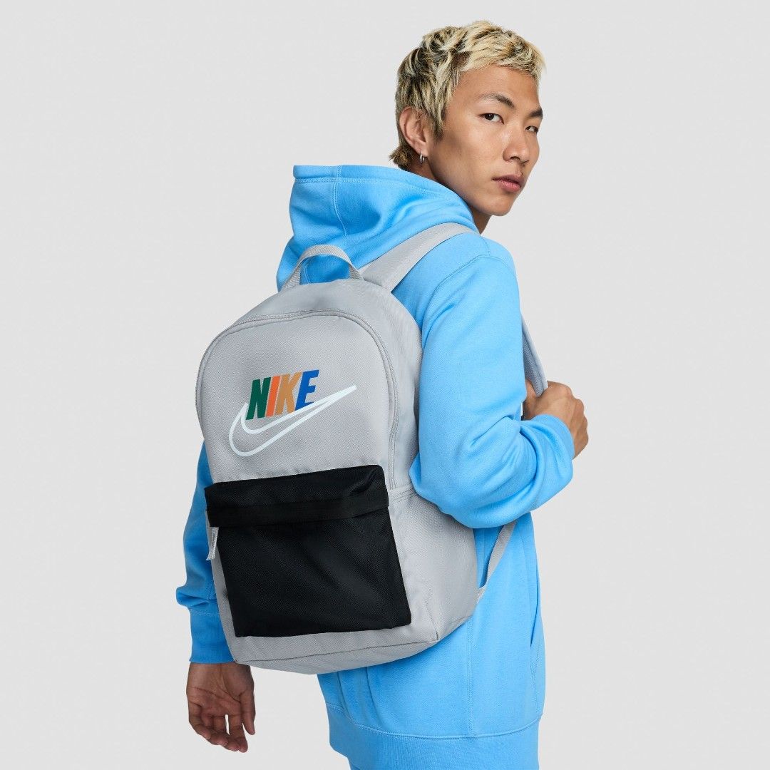 Nike Grey Backpack with Multi-Color Logo (Category: Backpacks) located in Mandaluyong City. Submitted by swiftbird_ed6c34 (Listing ID 1461417220, Image 3). Description: - Grey Nike backpack - Black front pocket and side pockets - Multi-color Nike logo design - Padded straps for comfort - Spacious interior - Ideal for school or everyday use.