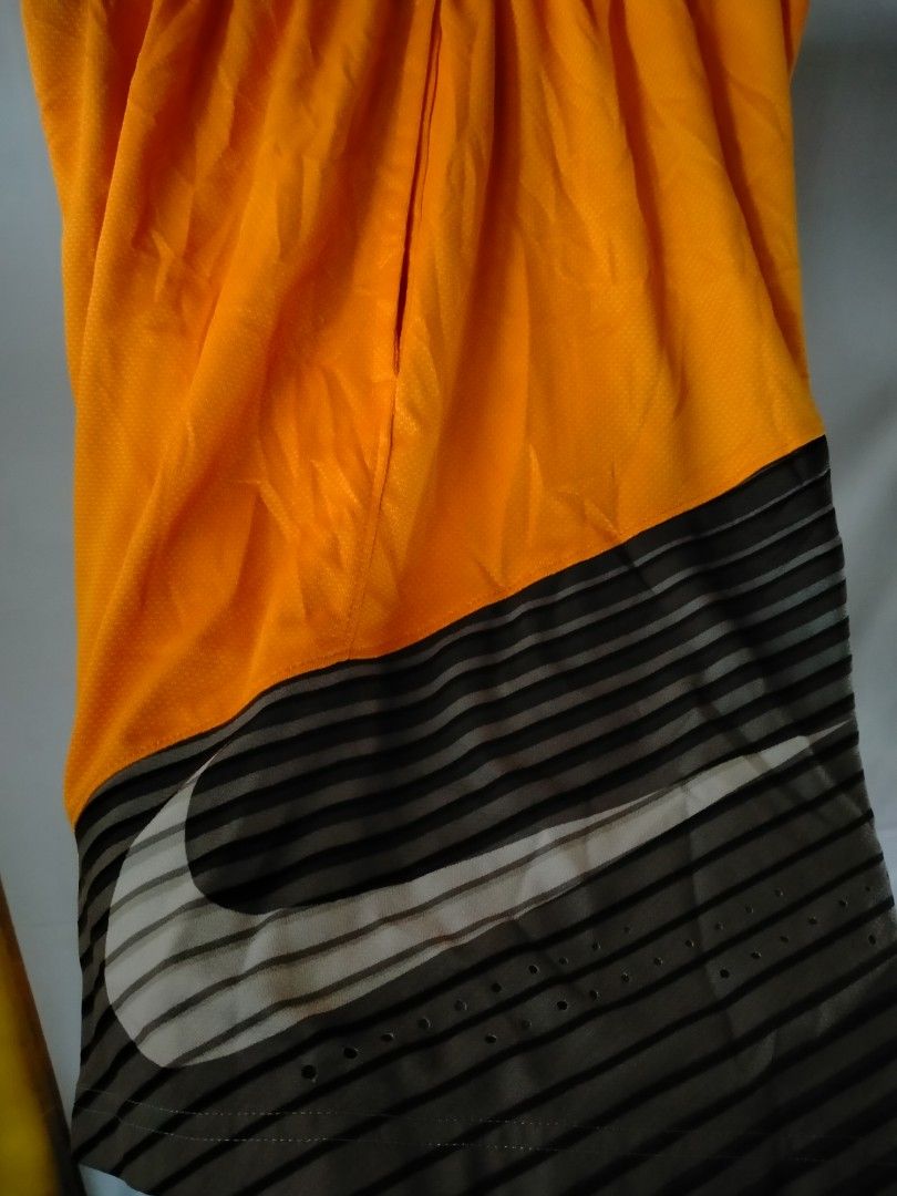 Nike Orange Basketball Shorts (Category: Shorts) located in Davao. Submitted by ervinpolino09 (Listing ID 1461431380, Image 2). Description: - Orange Nike basketball shorts - Elastic waistband with drawstring - Side pockets for convenience - Grey and black striped detail at the bottom - White Nike swoosh logo - Made in Thailand - Ideal for basketball, sports, or everyday casual wear Size 32-34 Length 19.5.