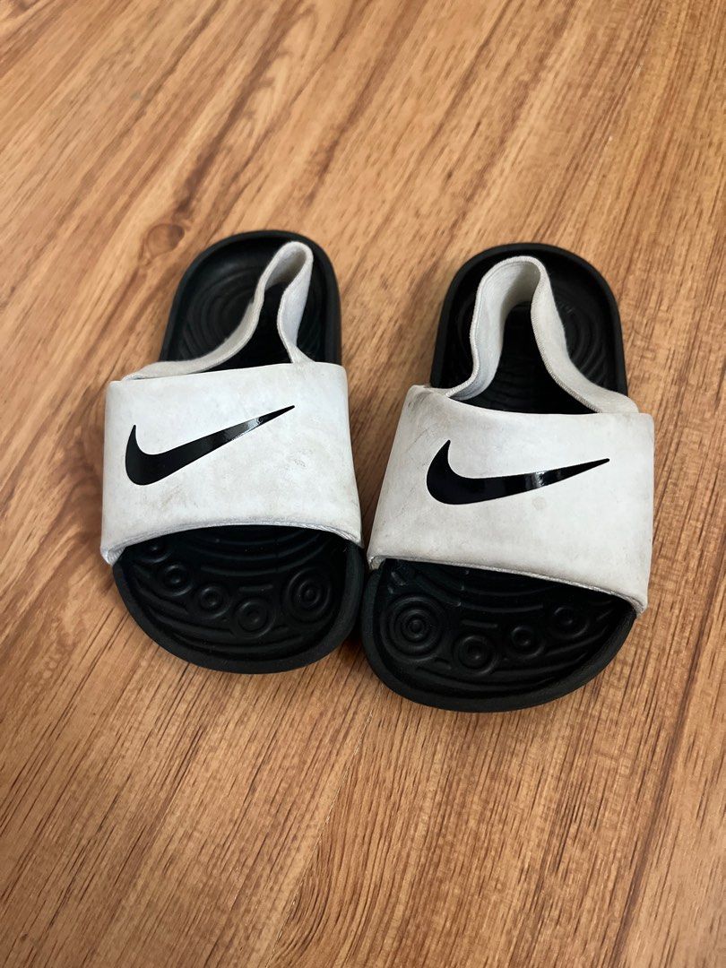 Nike Slides (Category: Babies & Kids Fashion) located in Pasig City. Submitted by torisstuff (Listing ID 1461390615, Image 1). Description: - Classic black and white Nike slides - Features the iconic Nike swoosh - Textured footbed for comfort - Durable black soles - Ideal for casual outings or post-sports relaxation Kids US 6c.