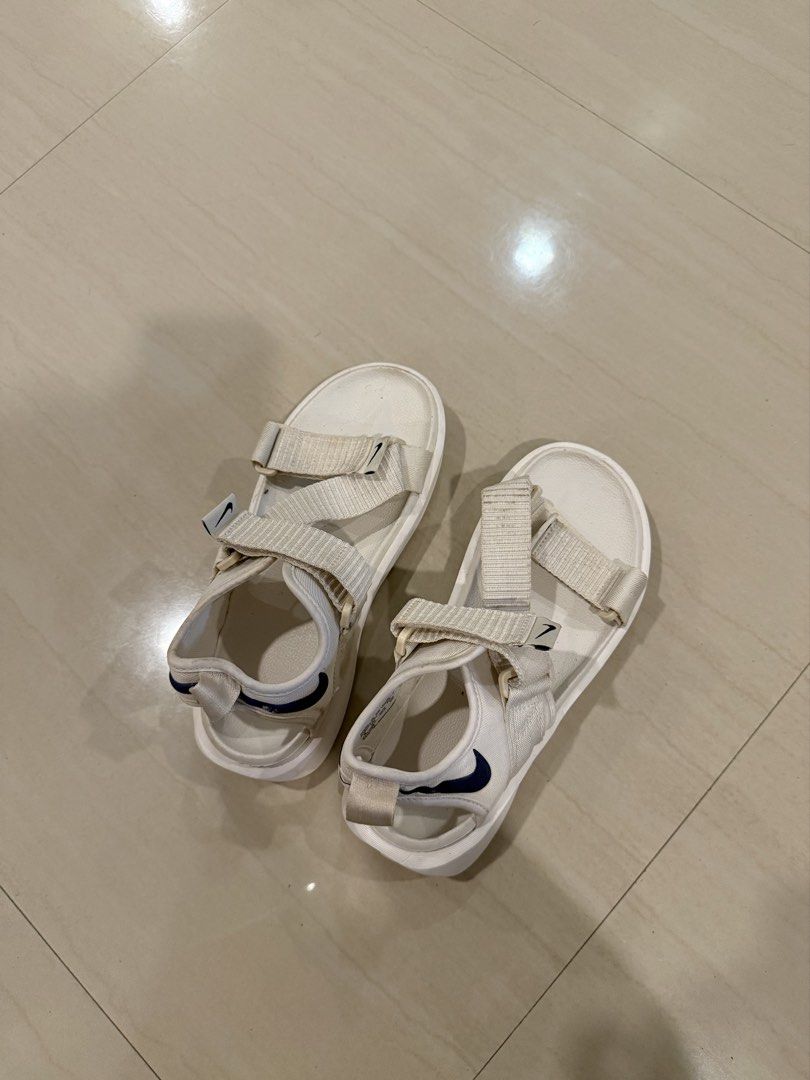 Nike White Sandals size 36 (Category: Flats & Sandals) located in Cagayan de Oro. Submitted by sugarrryyy (Listing ID 1461426831, Image 1). Description: - White Nike sandals - Classic navy blue Nike swoosh logo - Adjustable straps for a secure fit - Durable sole with excellent grip pattern - Comfortable for all-day wear - Ideal for casual outings and everyday use See photos for issues.