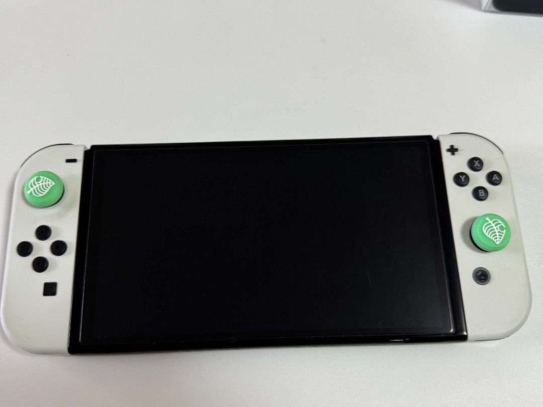 Nintendo Switch OLED (Pristine Condition) (Category: Nintendo) located in Manila. Submitted by trueowl.24db90 (Listing ID 1461371918, Image 3). Description: Pristine condition - rarely used Complete accessories - 2 Joycons (White) - Joycon protective case - 2 joycon strap - 1 joycon charging grip - 4 thumb grip - installed screen protector - 1 dock - 1 HDMI Cable - 1 Charger - Hard Case SLIGHTLY NEGOTIABLE Testing prior and upon meetup Meetup aro