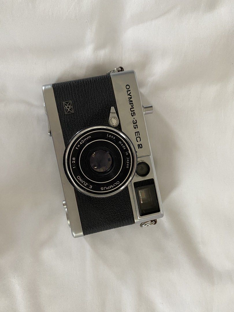 Olympus 35 EC2 35mm Film Camera (Category: Cameras) located in Baguio. Submitted by vivmrtn (Listing ID 1461417263, Image 1). Description: Olympus 35 EC2 FILM camera; Silver and black body E. Zuiko f=40mm 1:2.8 lens (some dust inside but rest assured the image quality is not affected Film compartment is clean; NO batteries but rest assured, camera is still working .