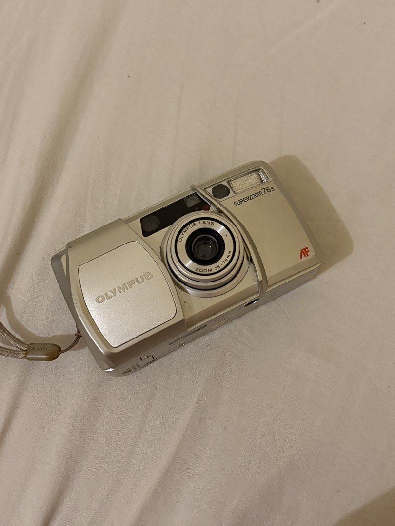 Olympus Superzoom 75s Autofocus Zoom Quartz Date Camera (Category: Cameras) located in Taguig. Submitted by aleksing (Listing ID 1461537919, Image 3). Description: - Olympus Superzoom 75s camera - Autofocus zoom lens - 38-76mm focal range - Built-in Quartz Date function - Includes wrist strap - Tested and confirmed working - Ideal for capturing memories.
