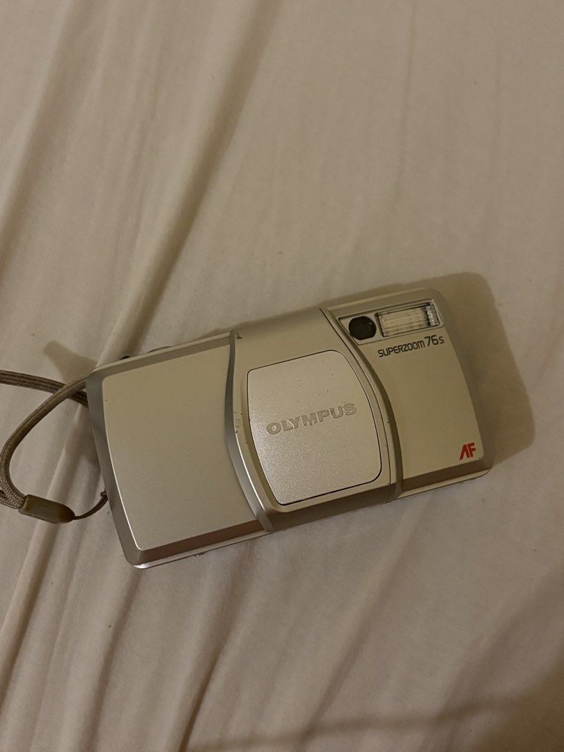 Olympus Superzoom 75s Autofocus Zoom Quartz Date Camera (Category: Cameras) located in Taguig. Submitted by aleksing (Listing ID 1461537919, Image 1). Description: - Olympus Superzoom 75s camera - Autofocus zoom lens - 38-76mm focal range - Built-in Quartz Date function - Includes wrist strap - Tested and confirmed working - Ideal for capturing memories.