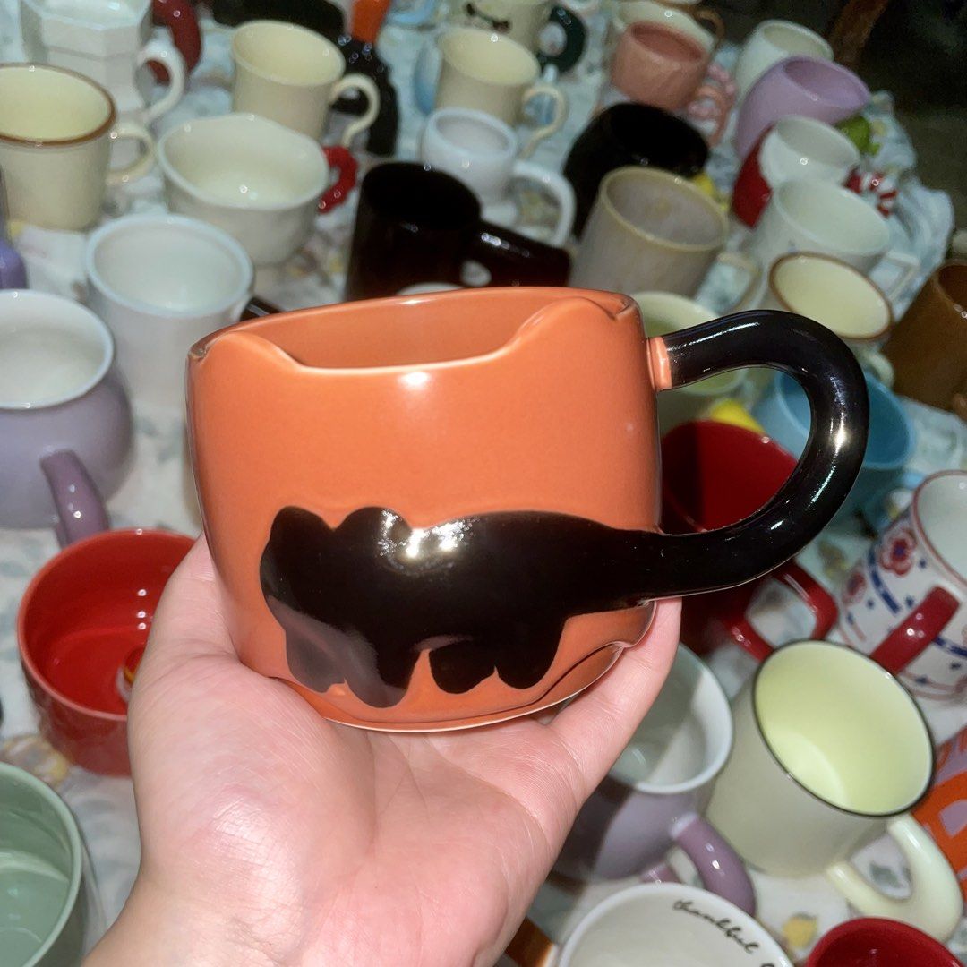 Orange Cat Paw Mug with Black Handle (Category: Coffee & Tea Tableware) located in Valenzuela. Submitted by baekhyunie_pau (Listing ID 1461559884, Image 1). Description: Orange cat paw mug. Black handle. Great for coffee/tea. Cat lover essential..