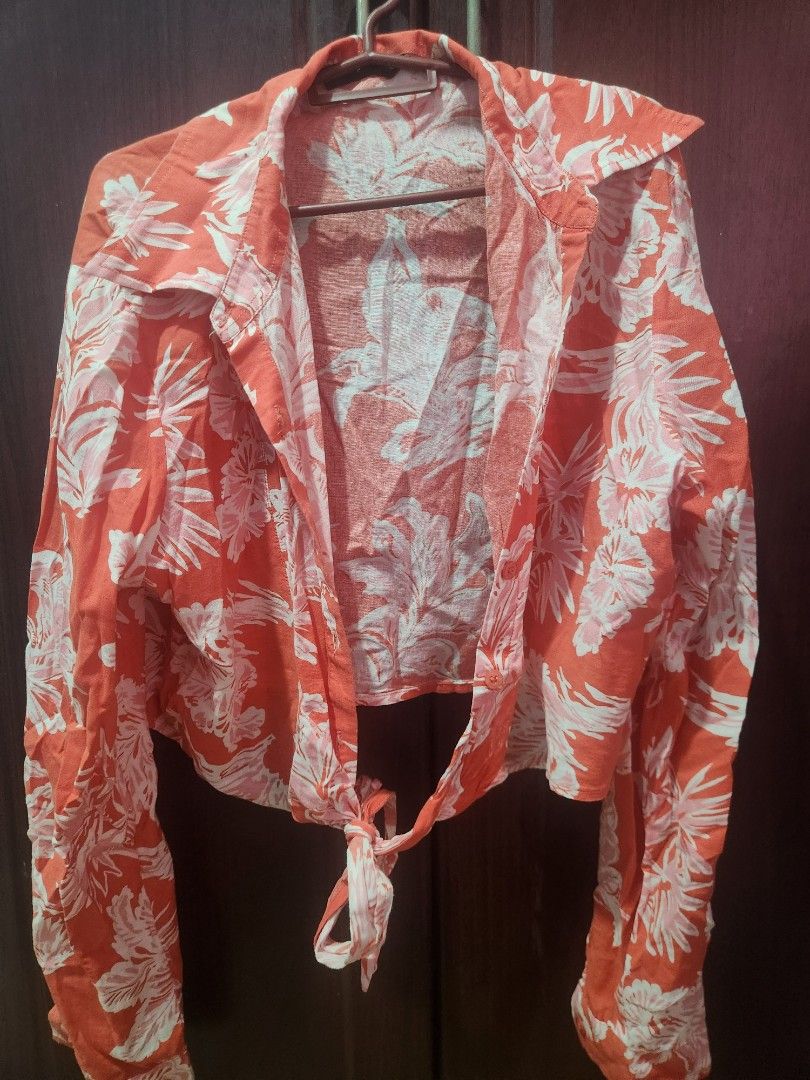 Orange Floral Print Tie-Front Top (Category: Blouses) located in Muntinlupa City. Submitted by yanyan1888 (Listing ID 1461366215, Image 1). Description: - Cute orange top with white floral print - Features a tie-front detail - Button closure - Lightweight and airy fabric - Ideal for casual outings or beach vacations - Easily styled with shorts or jeans.