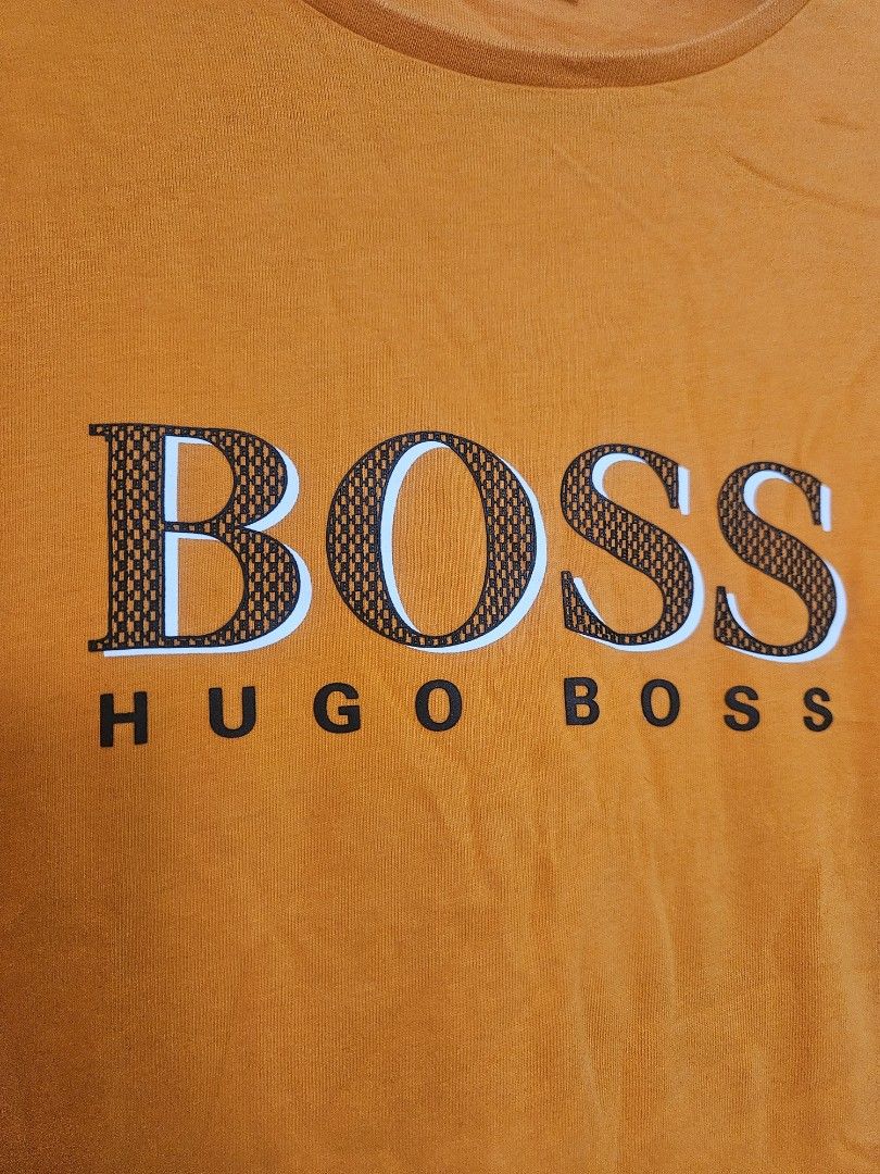 Orange Hugo Boss T-Shirt (Category: Tshirts & Polo Shirts ) located in Batangas. Submitted by golem08 (Listing ID 1461408969, Image 2). Description: - Orange Hugo Boss T-shirt - Short sleeves - Crew neck - Bold BOSS HUGO BOSS graphic on the front - Comfortable cotton material - Perfect for casual wear.