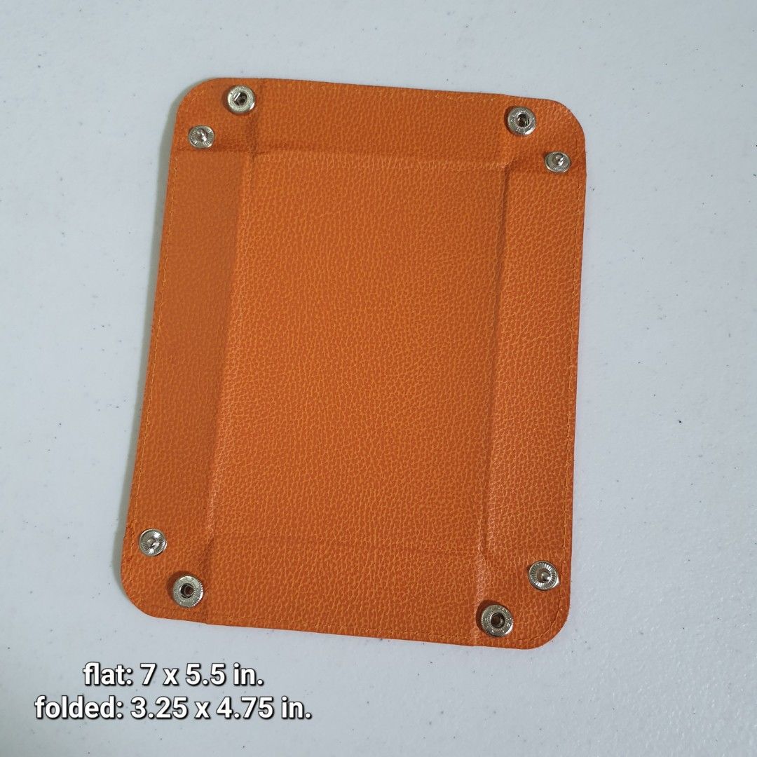 Orange Leather Foldable Catchall Tray (Category: Other Home Decor) located in Paranaque City. Submitted by cobien (Listing ID 1461408550, Image 1). Description: - Chic orange leather tray - Snaps together to form a convenient small dish - Ideal for organizing keys, coins, or small accessories - Folds flat for effortless storage - 6 pcs available - Dimensions (flat): 7 x 5.5 inches - Dimensions (folded): Approximately 3.25 x 4.75 inches - Perfect 
