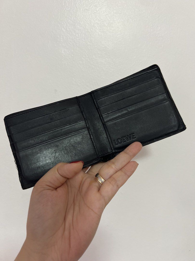 Original Loewe Black Leather Bifold Wallet (Category: Luxury Bags & Wallets) located in Cavite. Submitted by newtoyou88 (Listing ID 1461340342, Image 2). Description: - Authentic Loewe bifold wallet - Material: Black pebbled leather - Features: Multiple card slots - Design: Classic and timeless - Condition: Good, with some signs of wear - Ideal for: Everyday use.