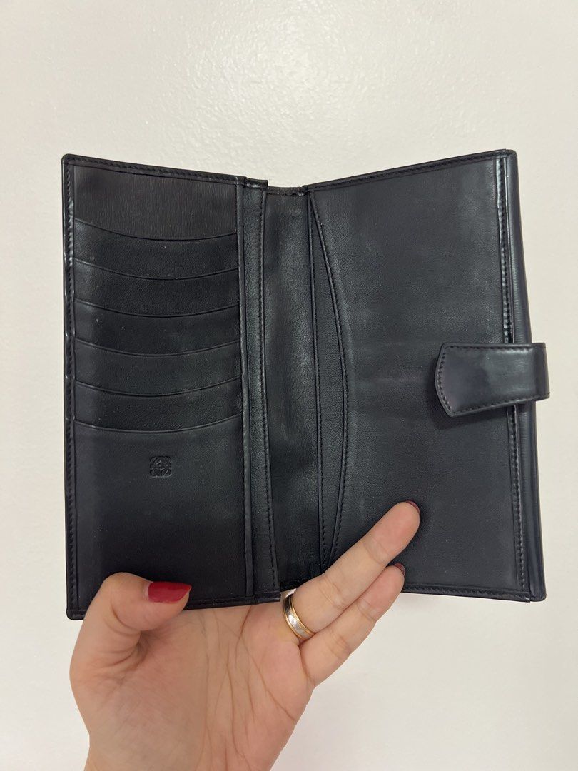 Original Loewe Black Leather Long Wallet (Category: Luxury Bags & Wallets) located in Cavite. Submitted by newtoyou88 (Listing ID 1461340551, Image 2). Description: - Authentic black leather Loewe wallet - Multiple card slots for ample storage - Main compartment for cash - Secure snap button closure - Expertly crafted in Spain -Vintage.