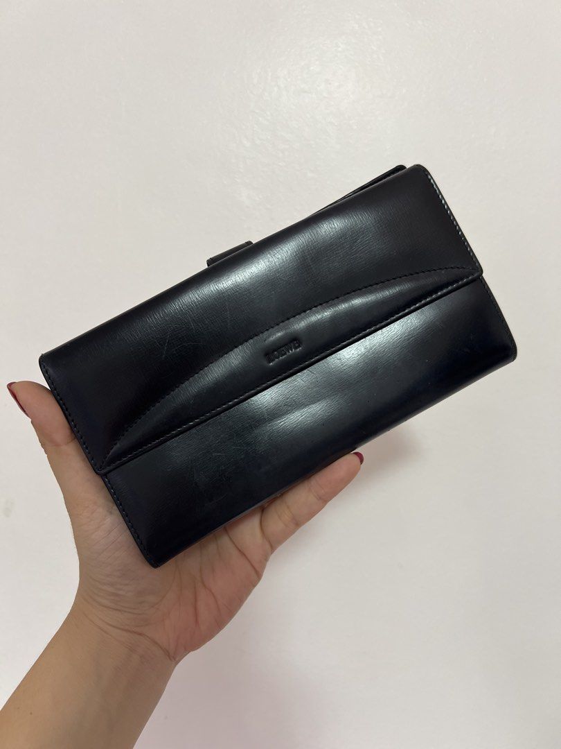 Original Loewe Black Leather Long Wallet (Category: Luxury Bags & Wallets) located in Cavite. Submitted by newtoyou88 (Listing ID 1461340551, Image 1). Description: - Authentic black leather Loewe wallet - Multiple card slots for ample storage - Main compartment for cash - Secure snap button closure - Expertly crafted in Spain -Vintage.