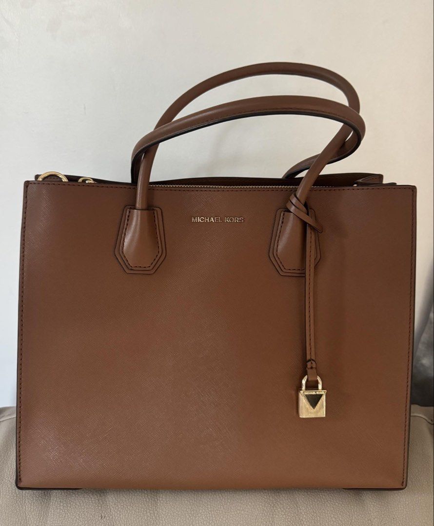 Original MK office bag (Category: Shoulder Bags) located in Davao. Submitted by lovedbyejane (Listing ID 1461503299, Image 3). Description: Selling preloved MK book tote. (with tag and extra strap for sling) good as new (with minimal signs of usage only) original price: 11k selling price: 5k.