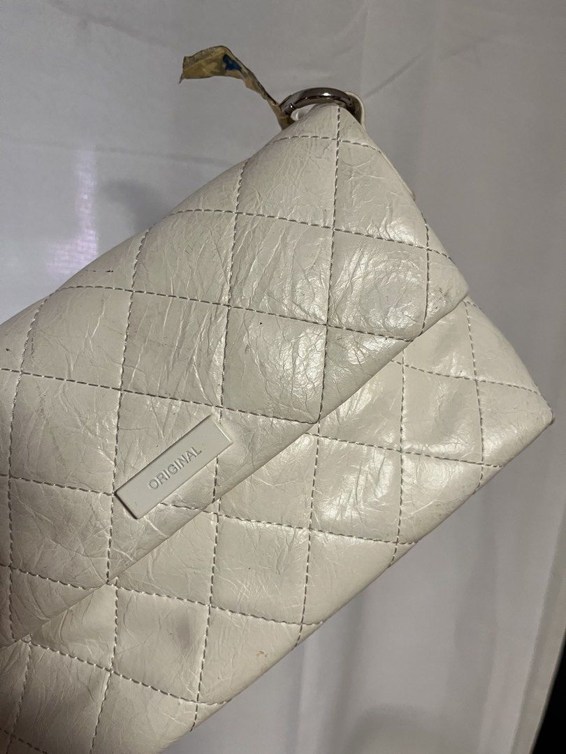 ORIGINAL Quilted Clutch Bag with Chain Strap (Category: Clutches) located in Quezon City. Submitted by rebagged.mnl (Listing ID 1461406055, Image 1). Description: - Chic white quilted clutch bag - Detachable chain strap included - Features 'ORIGINAL' brand logo on the front - Interior zippered pocket for essentials.
